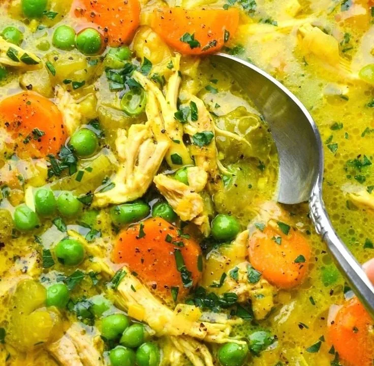 Bowl of anti-inflammatory turmeric chicken soup with herbs and spices