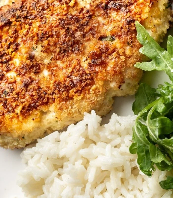 Savory chicken cakes served on a plate with fresh herbs
