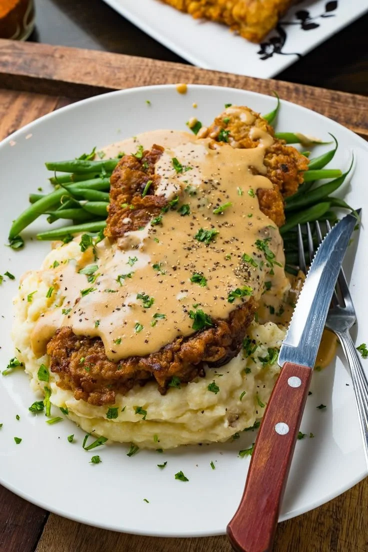 Delicious Chicken Fried Steak served with gravy and sides