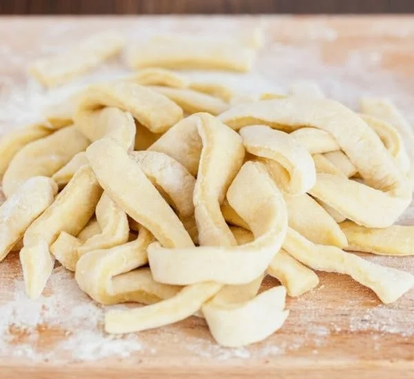 Freshly made egg noodles prepared from scratch for delicious meals.
