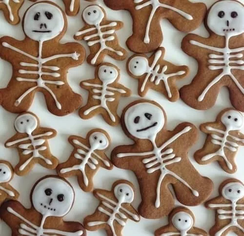 Halloween-themed gingerbread skeleton cookies decorated for a festive celebration
