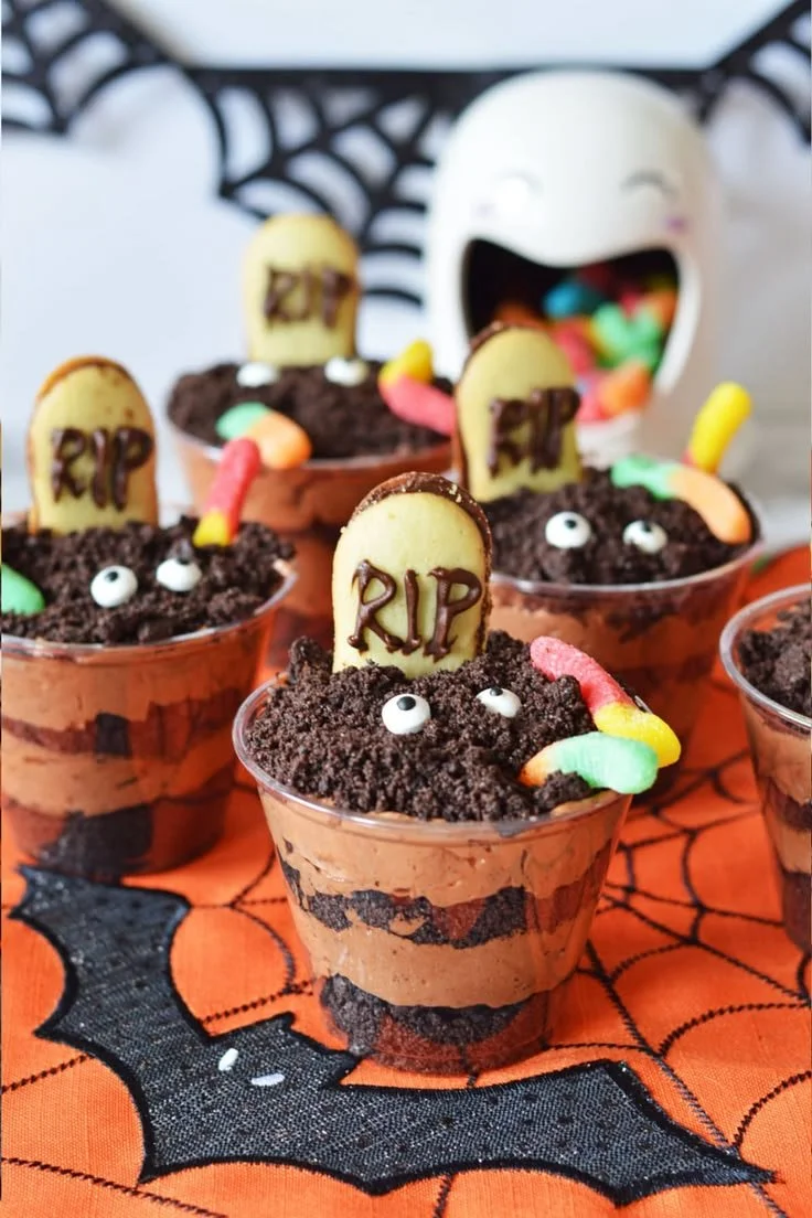 Delicious Halloween dirt pudding dessert served in spooky cups.