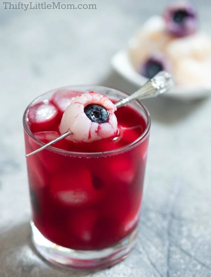 Colorful Halloween drinks for kids mocktails at a festive party table