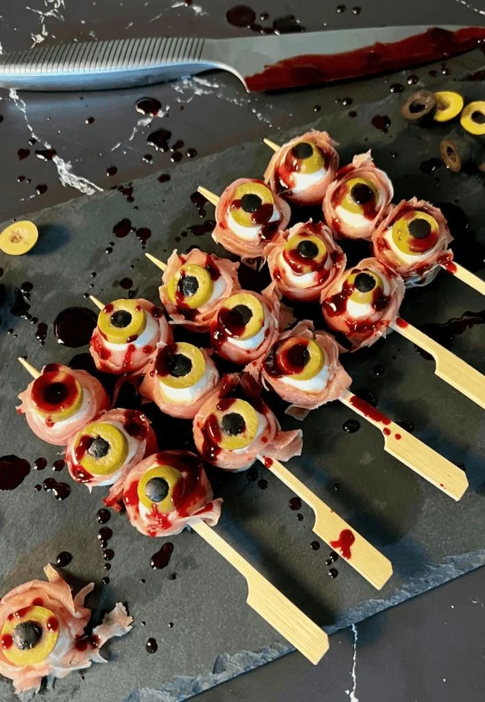 Halloween-themed prosciutto mozzarella skewers served on a platter