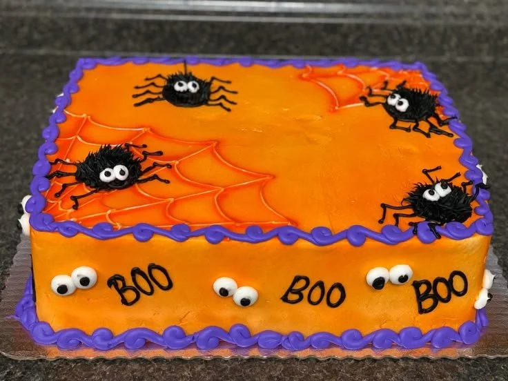 Spooky Halloween themed cake decorated with ghosts and pumpkins