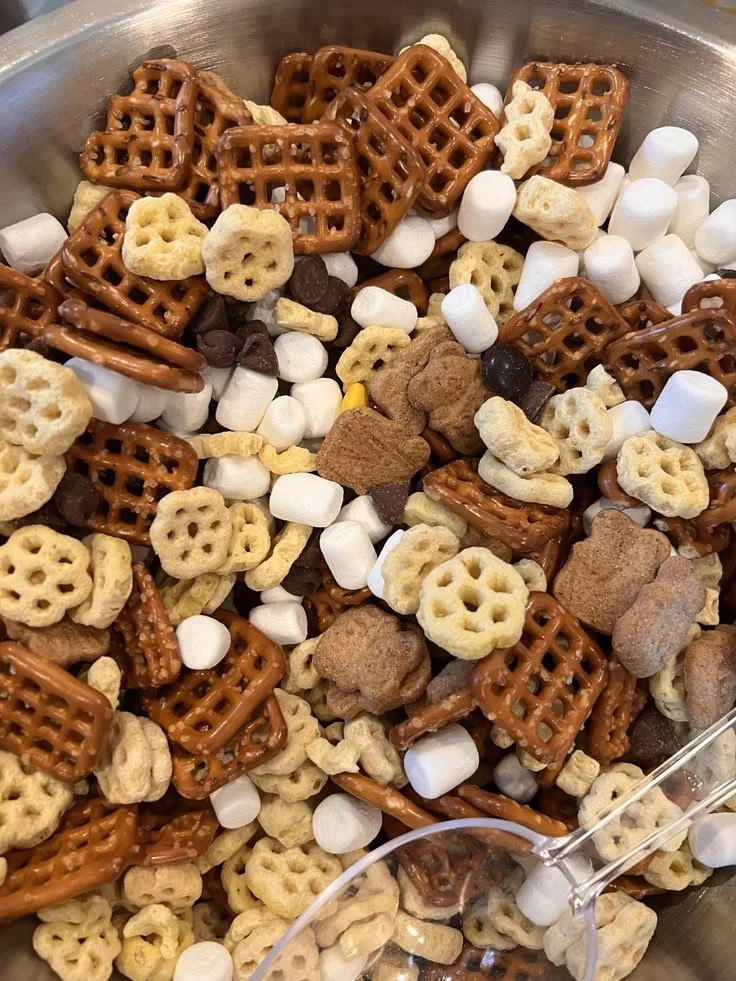 A bowl of Honeycomb Trail Mix with nuts, dried fruits, and honeycomb pieces.